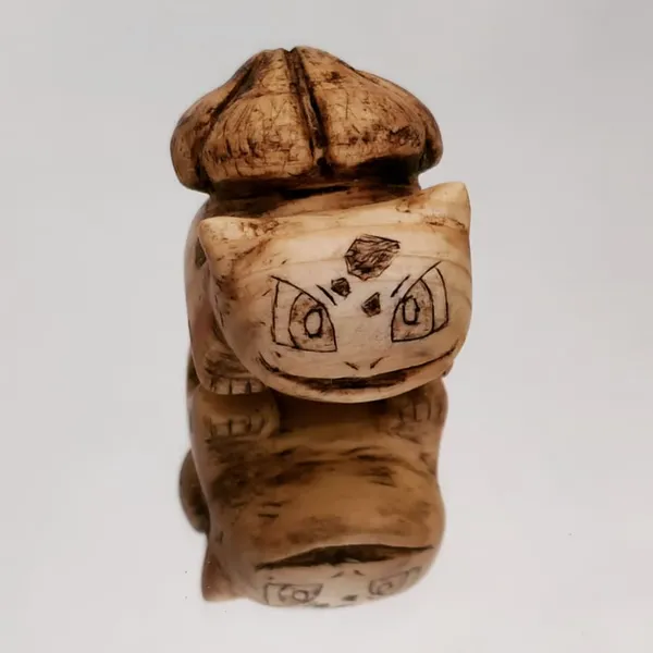 A small bulbasaur carved from pine wood. by Wondiu