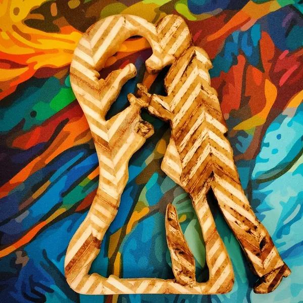 A silhouette of a dancing couple cut in patterned plywood, the woman visible only in negative space. by Wondiu