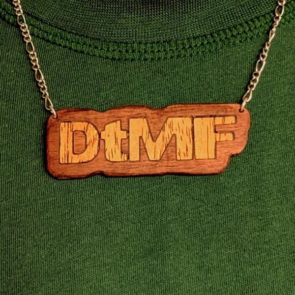 A pendant in walnut and obeche, celebrating Bad Bunny's album DeBÍ TiRAR MáS FOToS by Wondiu