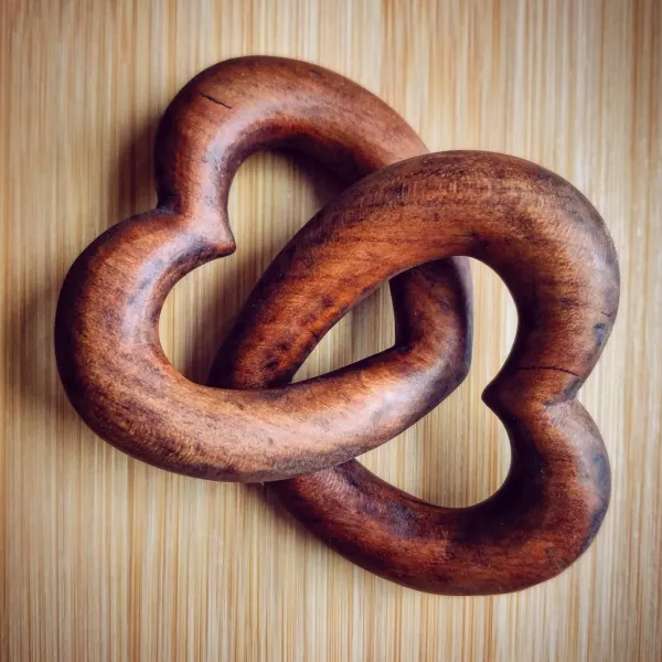 A carving of two linked hearts, carved from a single piece of sweet cherry wood. by Wondiu