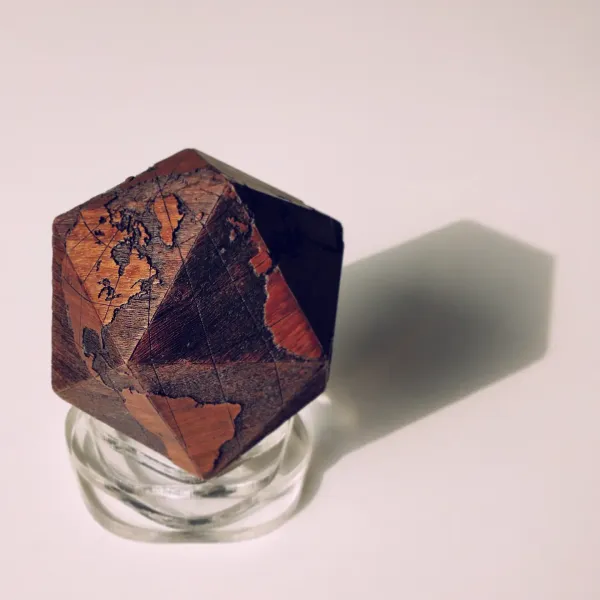 A globe in the shape of an icosahedron. Made of 20 triangles cut and engraved with a laser machine, then beveled and glued by hand. by Wondiu