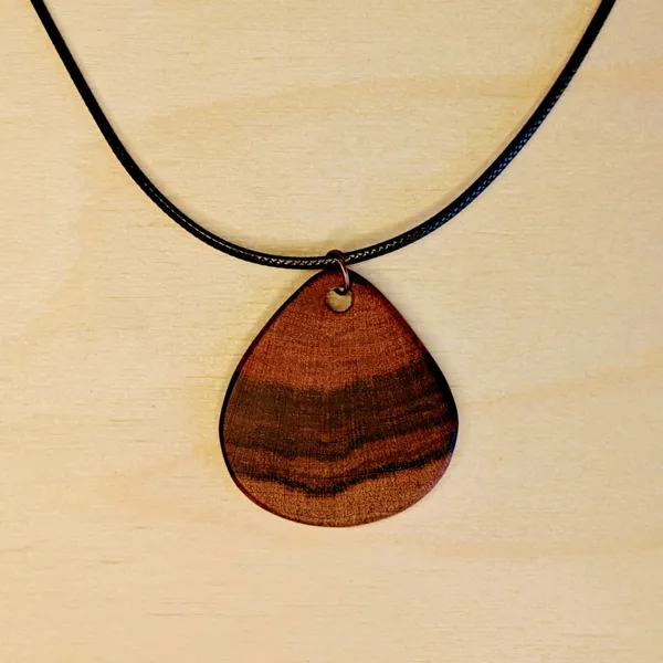 Pendant handcarved from Guava wood endgrain in the shape of a large drop. by Wondiu