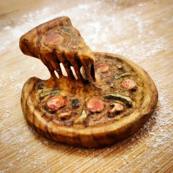 A cheesy pizza with an appetising slice pulled up, carved from olive wood. by Wondiu